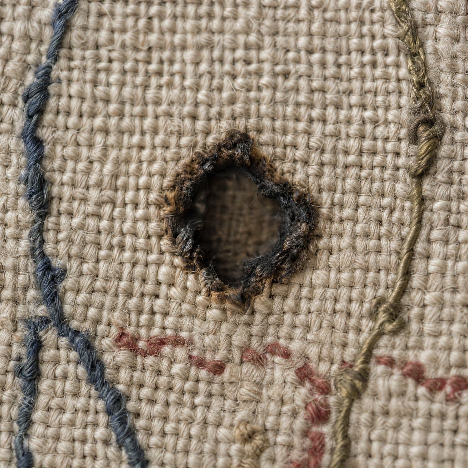 Burn: An opening with a hardened, weakened rim around it.