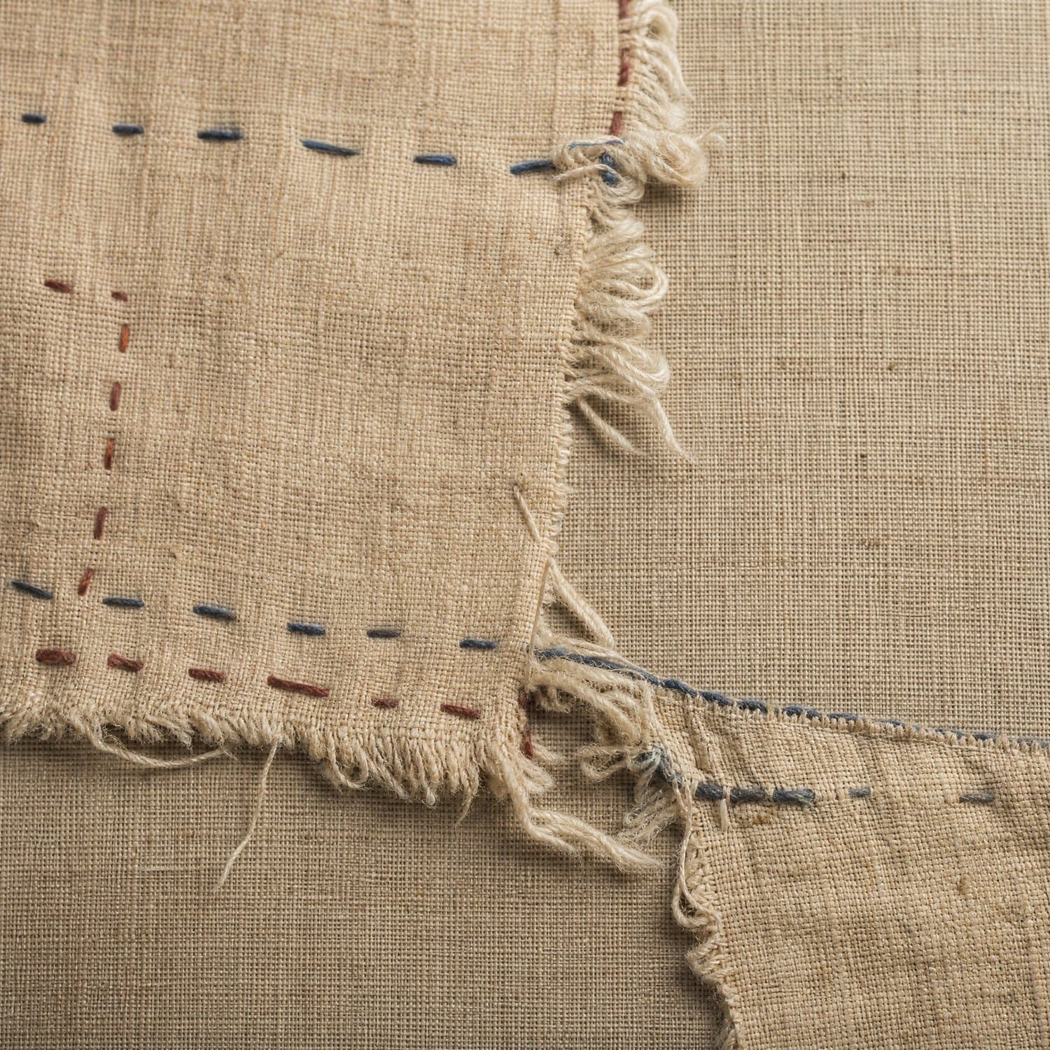 Tear: A split along a line, with the cloth still present on both sides.